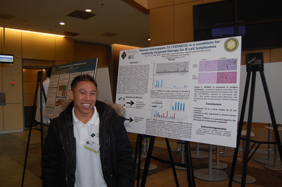 IGERT Trainee, Van Luu, preparing to share his research findings at the poster session during the 3rd International Symposium on LifeChips